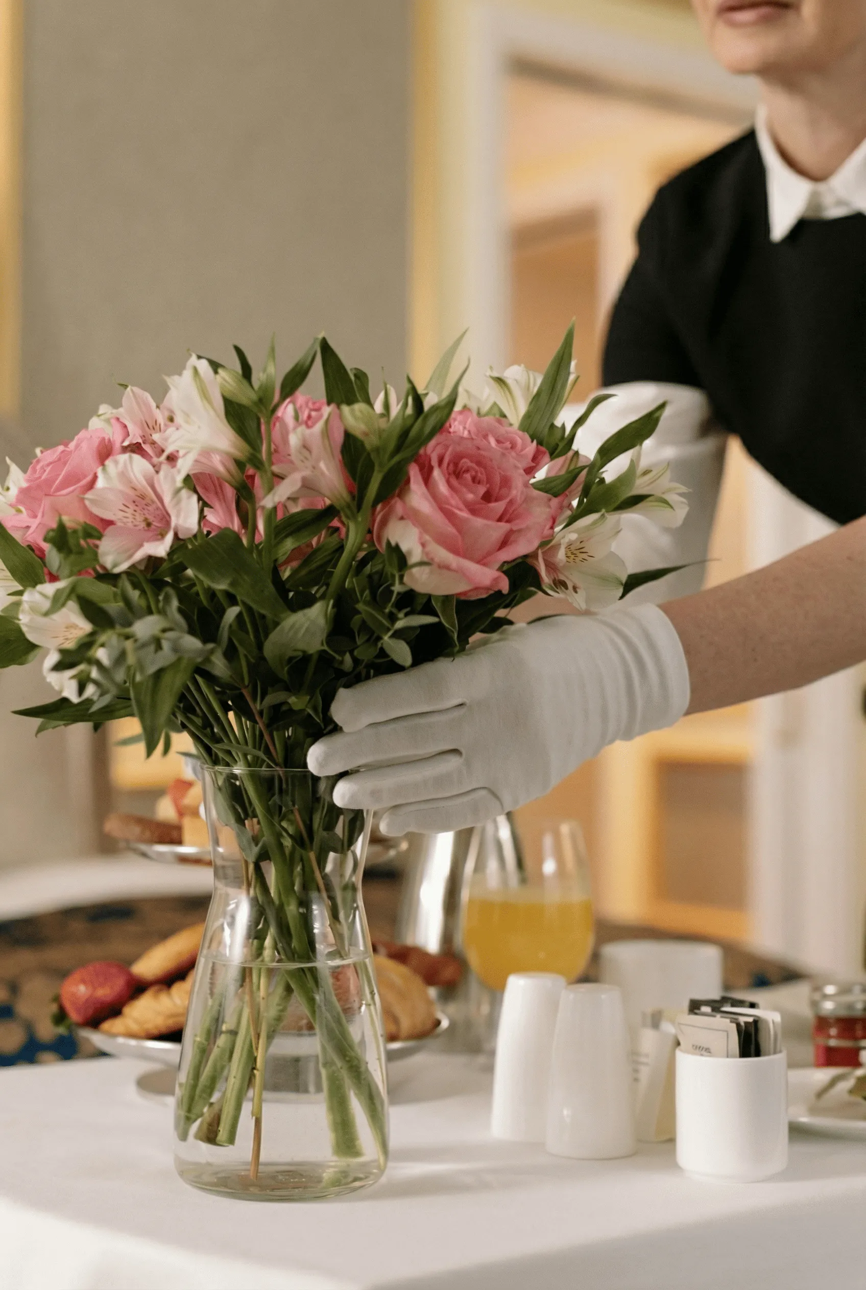 Hotel staff arranging fresh flowers
